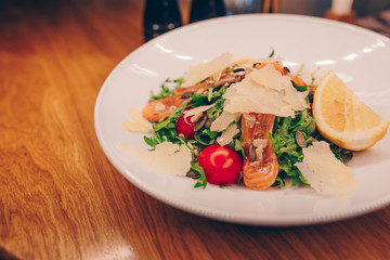 Waiter serving Salad rucola asparagus salad Caesar at restaurant, close up view. Eating and leisure concept. Toned image. Design healthy lifestyle Organic Gourmet and luxury concept service