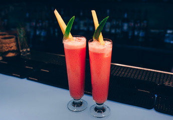 Sweet Famous juicy pink and white with ananas pineapple Author inspired Cocktail Drink -on bar counter . Close-up Top view . Copy paste space for design people and luxury service barman in nightclub