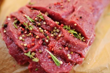 raw beef fillet with pepper and thyme, ready to grill.