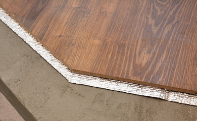Hardwood floor installation layers with insulation membrane. Flooring layers.
