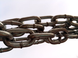 Obraz premium A chain is a serial assembly of connected pieces, called links, typically made of metal, with an overall character similar to that of a rope in that it is flexible and curved in compression but linear