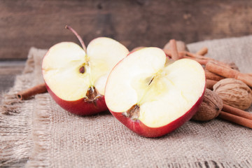 cinnamon sticks and apples on wooden background
