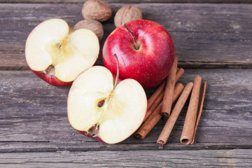 cinnamon sticks and apples on wooden background