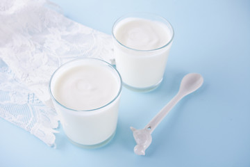 Yogurt in glass on a table with white napkin.