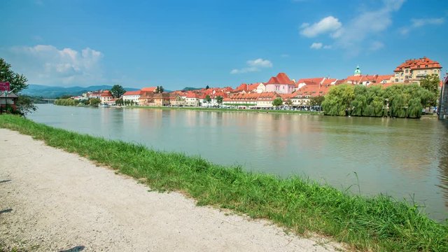 A nice city and a river. It's a beautiful sunny day, the river looks peaceful.