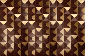 Brown and gold convex tiles with leather surface texture background. Looks like wooden wall tiles.
