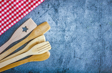 Kitchen utensils on a wooden background, copy space, top view