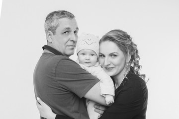 baby on the hands of parents on a white background.