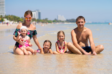 Fototapeta na wymiar Big happy family is having fun at beach. concept of a large family at sea.beach fashion.