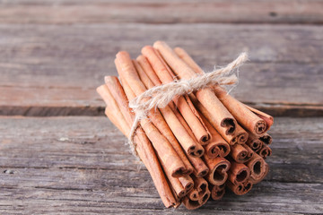 cinnamon sticks on wooden background