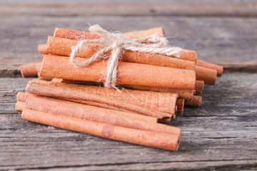 cinnamon sticks on wooden background