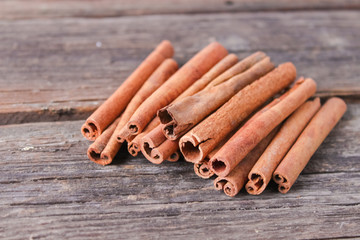 cinnamon sticks on wooden background