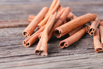 cinnamon sticks on wooden background