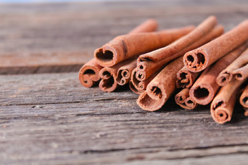 cinnamon sticks on wooden background