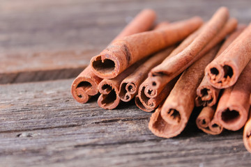 cinnamon sticks on wooden background