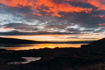 Red sunset on the shore of the lake.