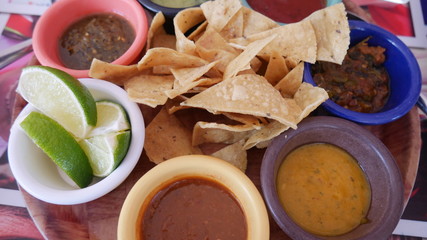 Tortilla with different dipping sauces and limes