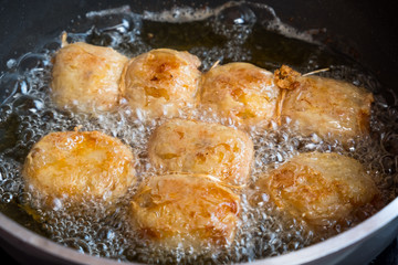 pork roll frying in pan at the kitchen. it's unhealthy food that contain many of cholesterol and fat.