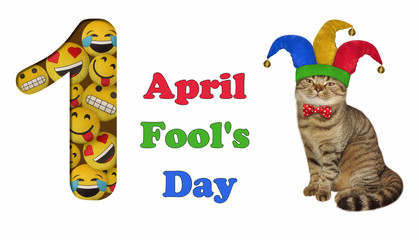 The funny cat is wearing a jester hat and a red a bow tie. A large number one filled with emoticons. April fools day.