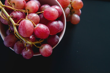 A bowl with fresh red grapes