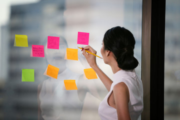 Young woman working in the office, doing plan