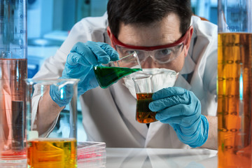 Scientist mixing fluids in the lab