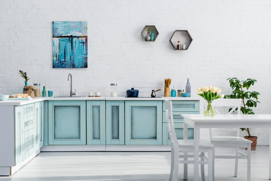 interior of turquoise and white kitchen full of sunlight
