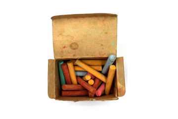 color chalks stick in old paper box isolated on white background