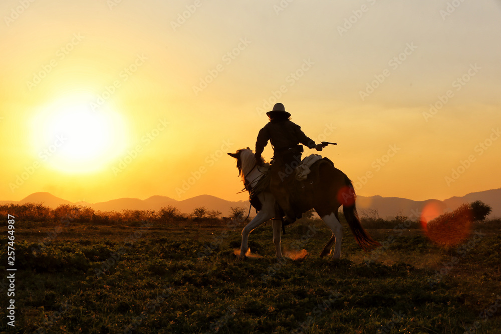 Wall mural cowboy and horse  at first light,mountain, river and lifestyle with natural sunset light background