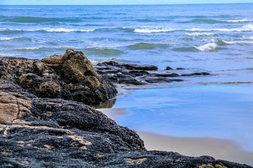 Fototapeta na wymiar Rocky shoreline is waves swept, Murawai Beach, Auckland, New Zealand