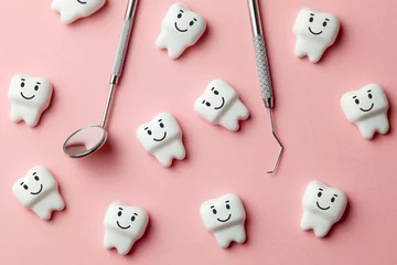 Acrylic prints Dentists Healthy white teeth are smiling on pink background and dentist tools mirror, hook.