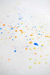 Obraz na płótnie Canvas Watercolor splash background. Orange, yellow, blue colorful paint drops texture. Paint splatter, poster for your design. Vertical
