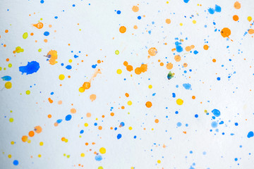 Watercolor splash background. Orange, yellow, blue colorful paint drops texture.  Paint splatter, poster for your design