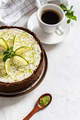 Homemade cheesecake with lime and mint for dessert - healthy organic summer dessert pie cheesecake. Cheese cake with a cup of coffee on white background. Copy space