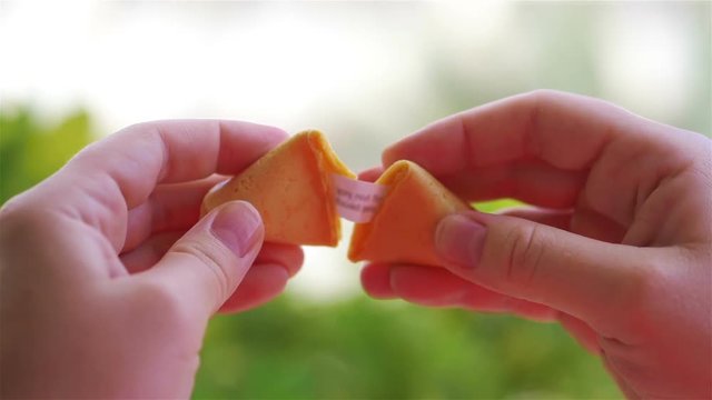 Opening chinese fortune cookie with a card inside in slow motion 180fps