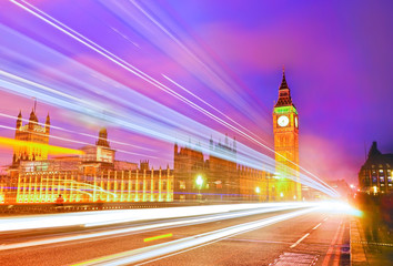 Fototapeta na wymiar Houses of Parliament from Westminster Bridge with lots of cars passing through in London at dusk.