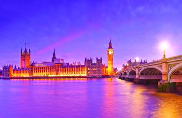 Fototapeta na wymiar View of the Houses of Parliament and Westminster Bridge along River Thames in London at dusk.