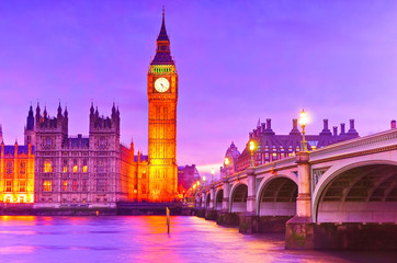 Fototapeta na wymiar View of the Houses of Parliament and Westminster Bridge along River Thames in London at dusk.