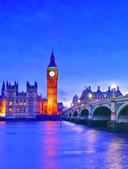 Obraz na płótnie Canvas View of the Houses of Parliament and Westminster Bridge along River Thames in London at night.