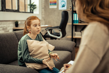 Depressed young girl having a session with psychologist