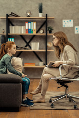 Professional female psychologist listening to her patient