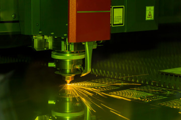 Close up Industrial laser and plasma cutting of steel sheet or metal sheet with sparks fly