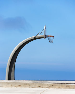 Basketball hoop and backboard against blue sky