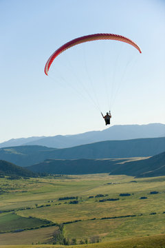 Jeff Annetts paraglides high above the Jackson Valley, Jackson WY.