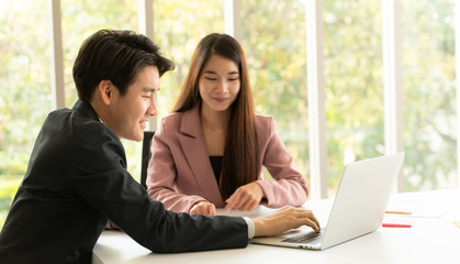 Fototapeta premium A man and women in office,signature for agreement and training