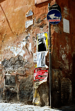 Street corner with signage and flyers.