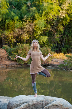 36 year old blond woman doing yoga postures in outdoor setting.