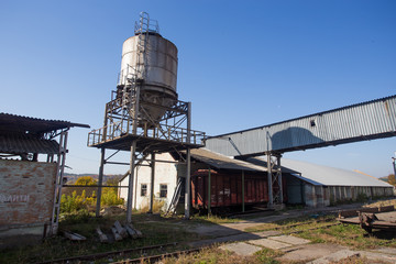 Buildings for food storage and transportation. The metal structures of the tower and towers in the obsolete plant of Eastern Europe, the impact on environmental pollution.