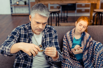 Serious nice man holding a bottle with the mixture