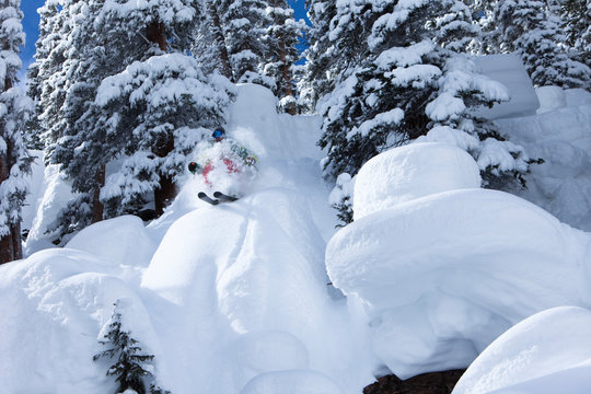 A alpine skier blasts through a powder pillow at Vail Resorts, in Vail, Colorado.